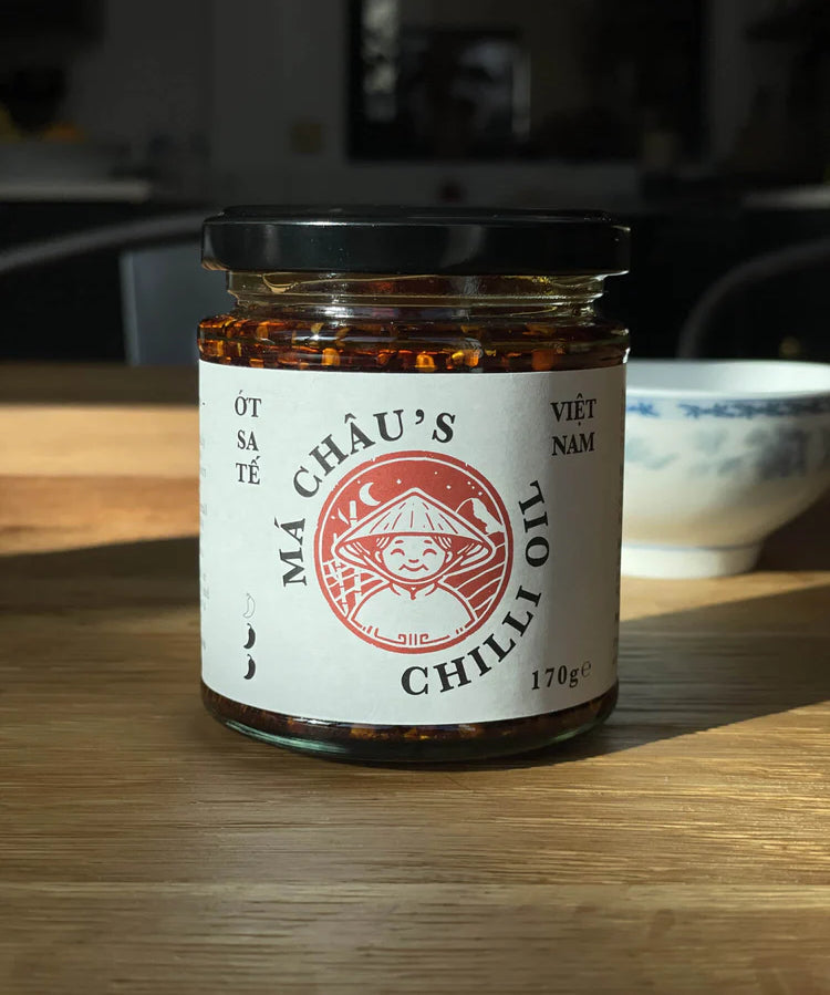 Jar of Mâ Cháu's Chilli Oil on a wooden surface