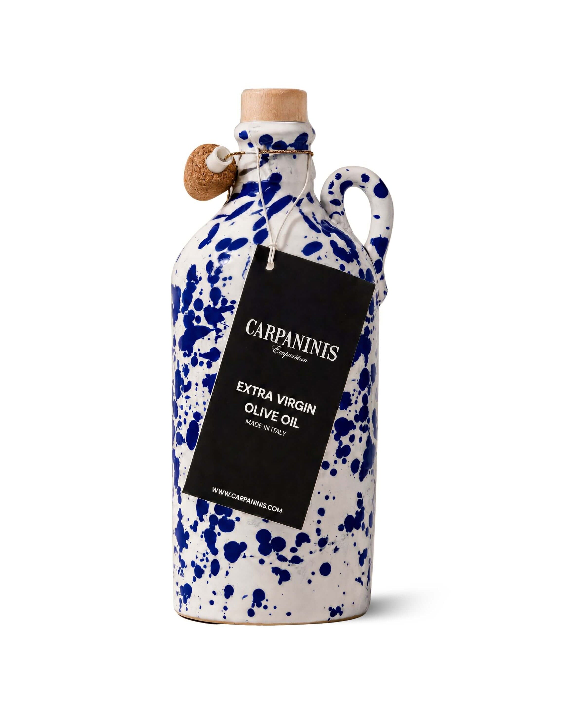 A Carpaninis ceramic olive oil bottle with a white glaze, blue speckled pattern, and a cork stopper, featuring a black hanging label that reads 'Carpaninis Extra Virgin Olive Oil'.