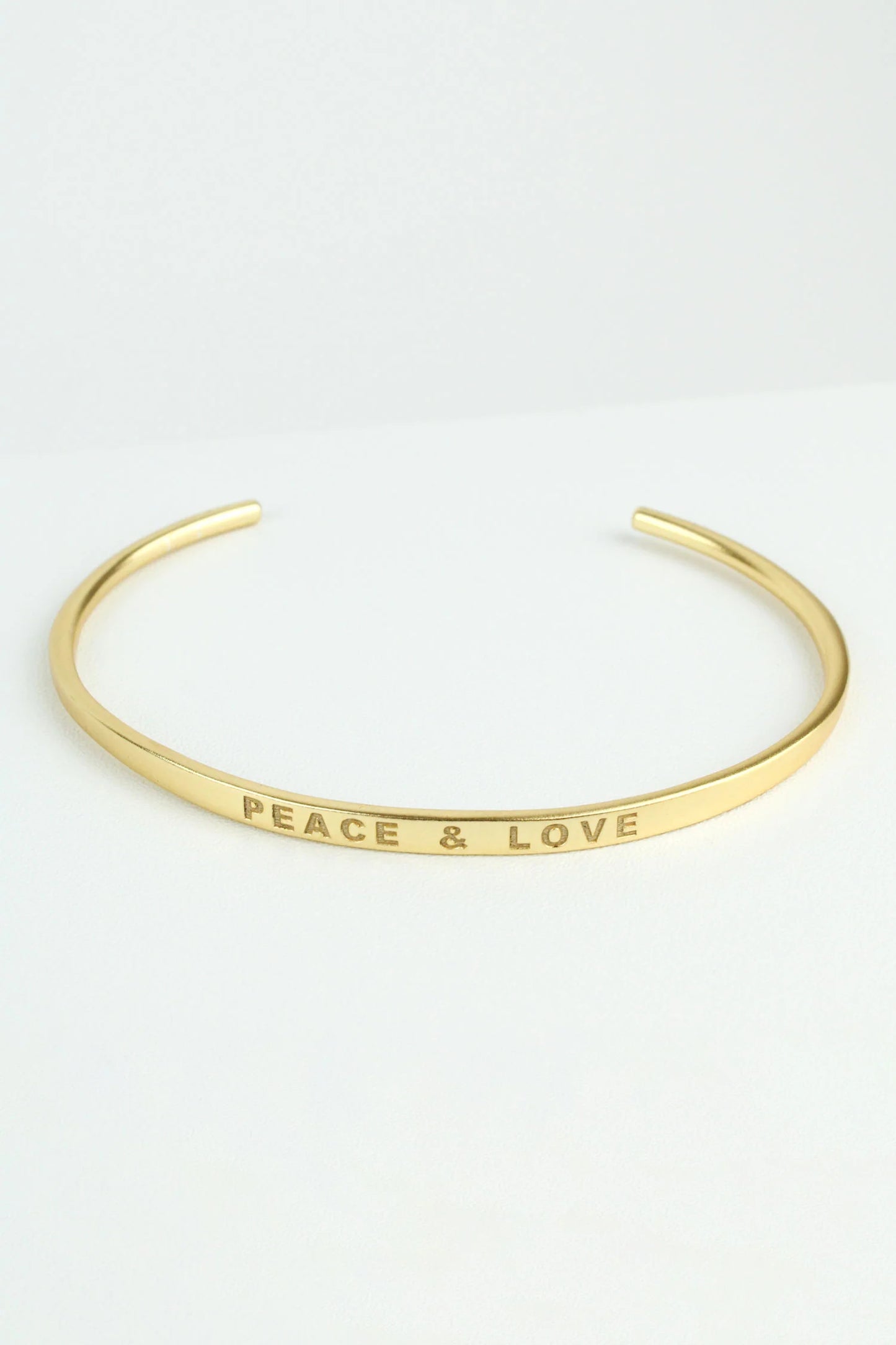 The Every Space handcrafted, delicate gold bangle with 'Peace and Love' feature stamped and adjustable fit by My Doris