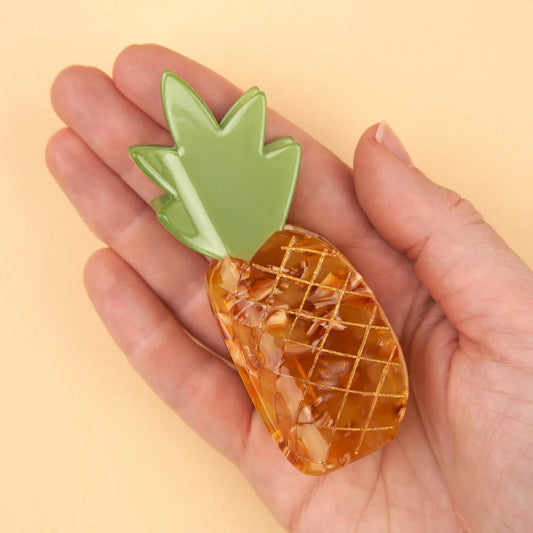 Orange pineapple-shaped hair claw with  green spikey leaves by Coucou Suzette