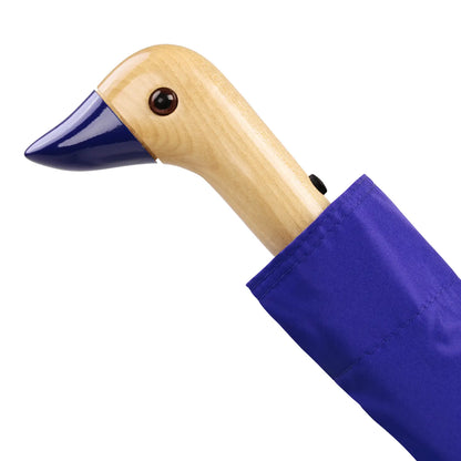 The Every Space compact, eco-friendly and lightweight, Royal Blue Umbrella, with 100% recycled, wind resistant fabric on a high-strength steel frame, sustainably sourced birch handle made from one solid piece of wood, and automatic open button, by Original Duckhead.