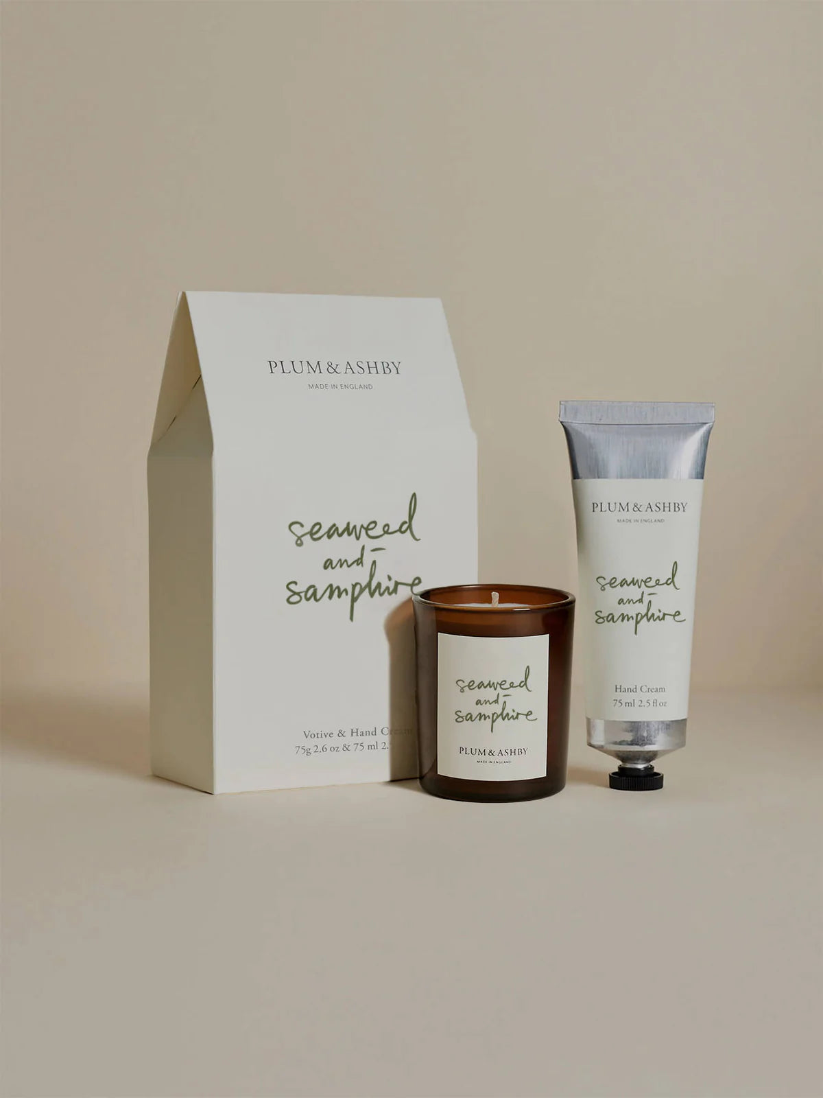 Plum & Ashby Seaweed and Samphire candle and hand cream set in front of the gift box