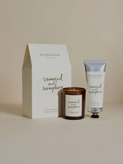 Plum & Ashby Seaweed and Samphire candle and hand cream set in front of the gift box