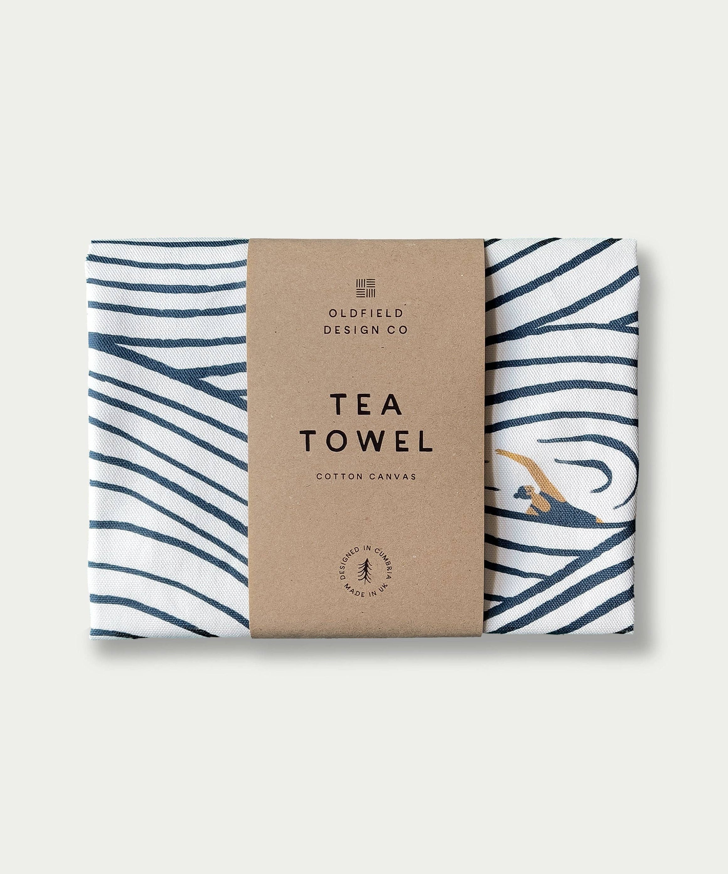 Tea towel with wavy blue pattern on a cardboard packaging labeled 'Oldfield Design Co' against a white background.