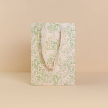 Pale green, jungle print gift bag by Cai & Jo is plastic-free and zero waste.  Nontoxic, plastic-free, reusable, and includes speckled cotton handles.