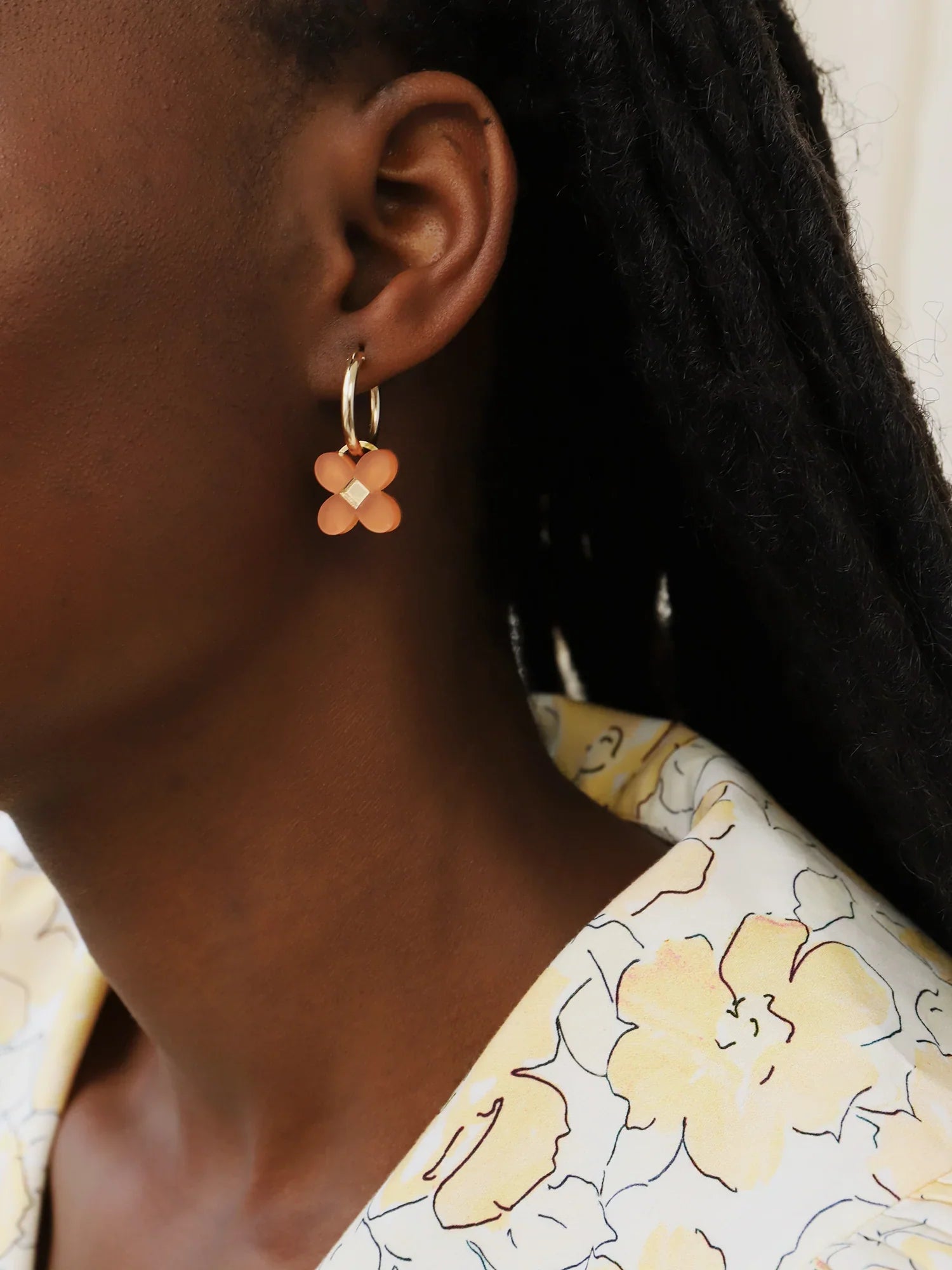 The Every Space Bella hoop earrings in filled gold and terracotta acrylic by Wolf & Moon