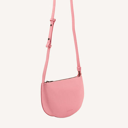 The Every Space high quality grain pink bloom vegan leather Half Moon shoulder bag with a black YKK zipper and an internal pocket by Monk & Anna