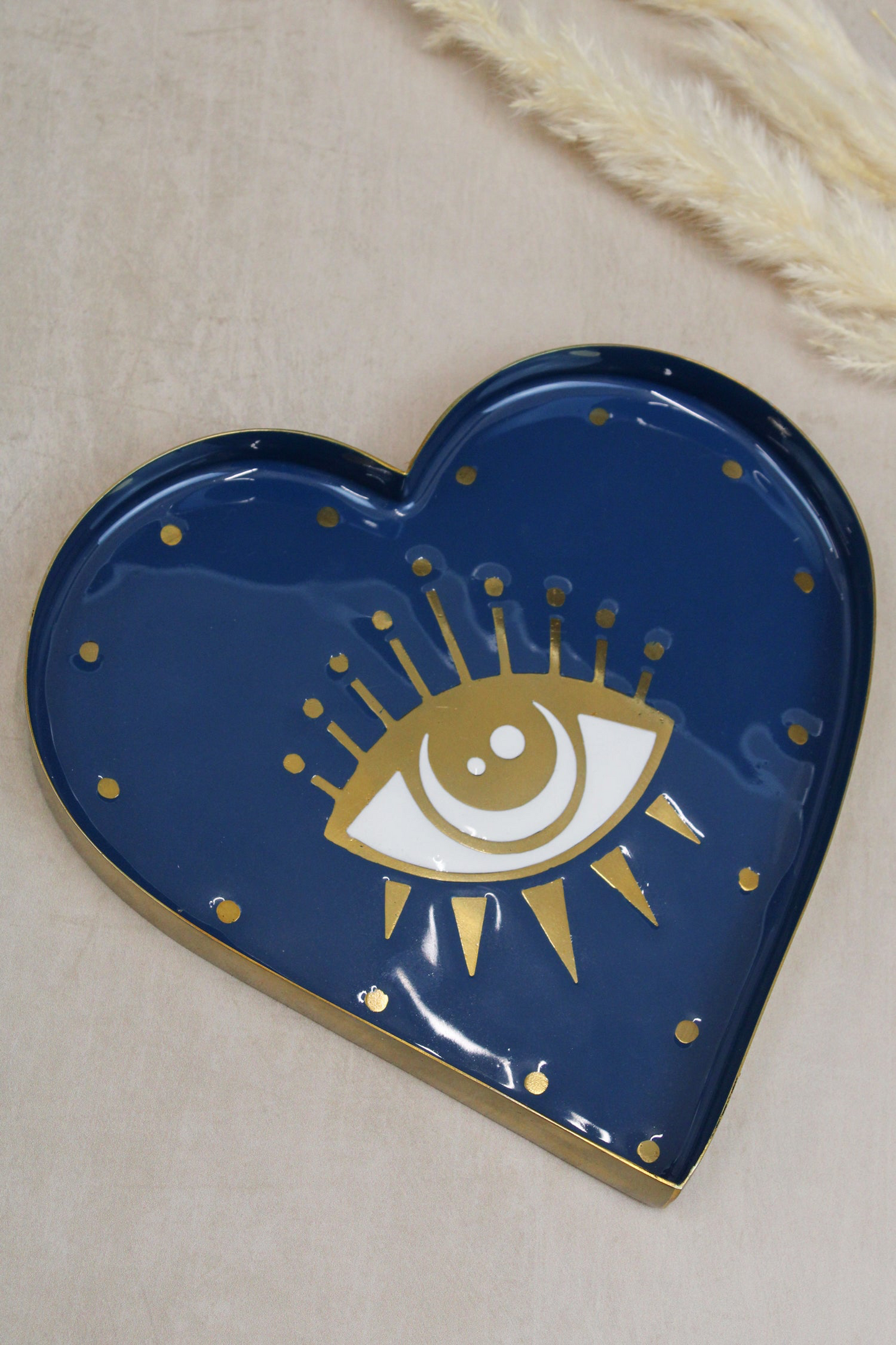 The Every Space brass and hand-enamelled heart-shaped Eye Trinket Dish with a gold eye motif by My Doris