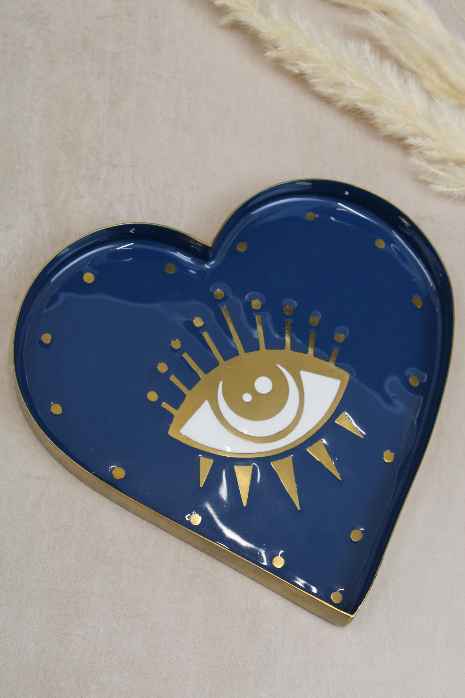 The Every Space brass and hand-enamelled heart-shaped Eye Trinket Dish with a gold eye motif by My Doris
