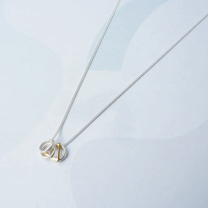 The Every Space Jessie necklace with sterling silver chain and sterling silver & gold filled charms by Custom Made UK