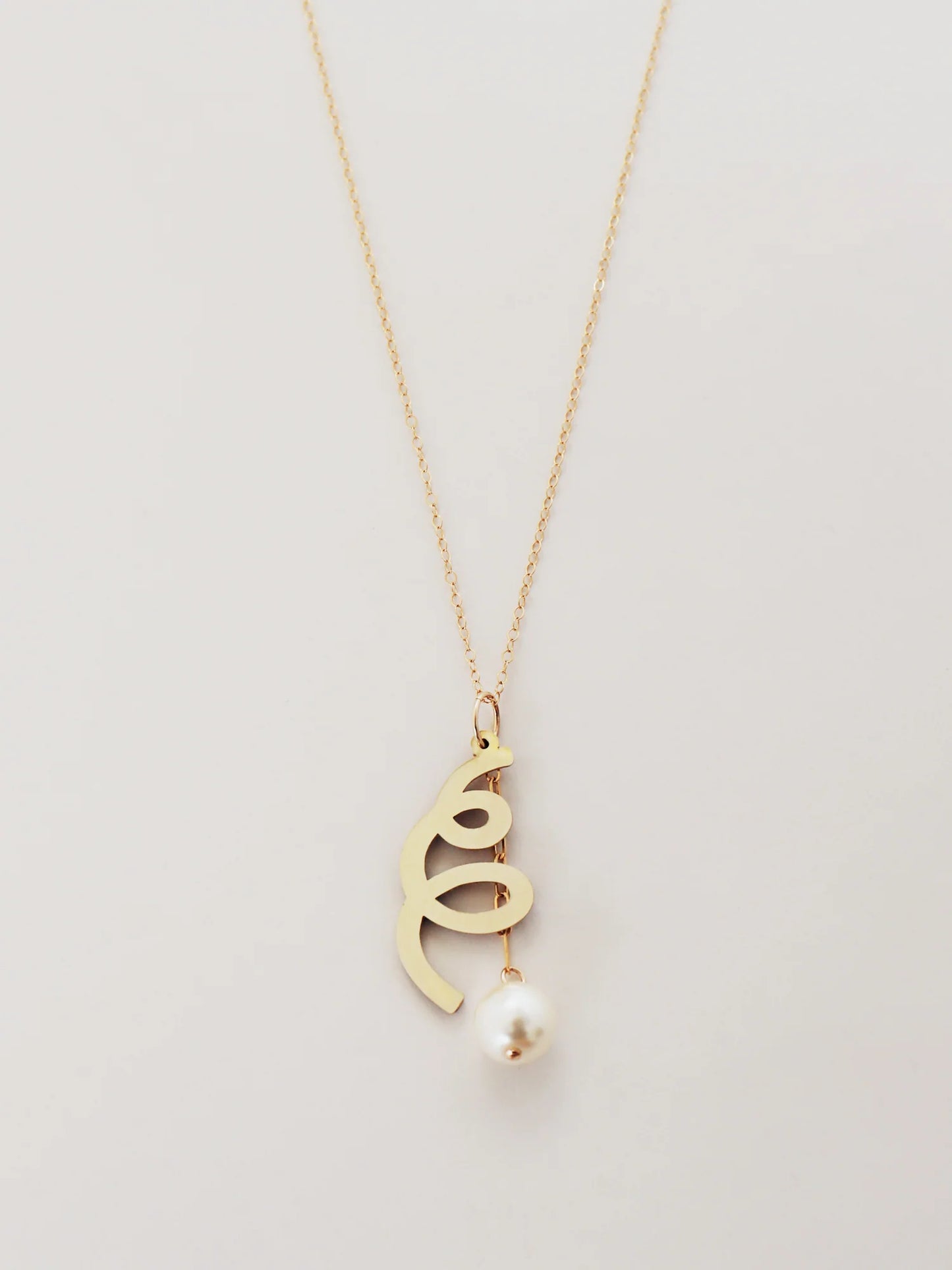The Every Space Lola necklace with gold filled chain and brass & glass purl pendant by Wolf & Moon