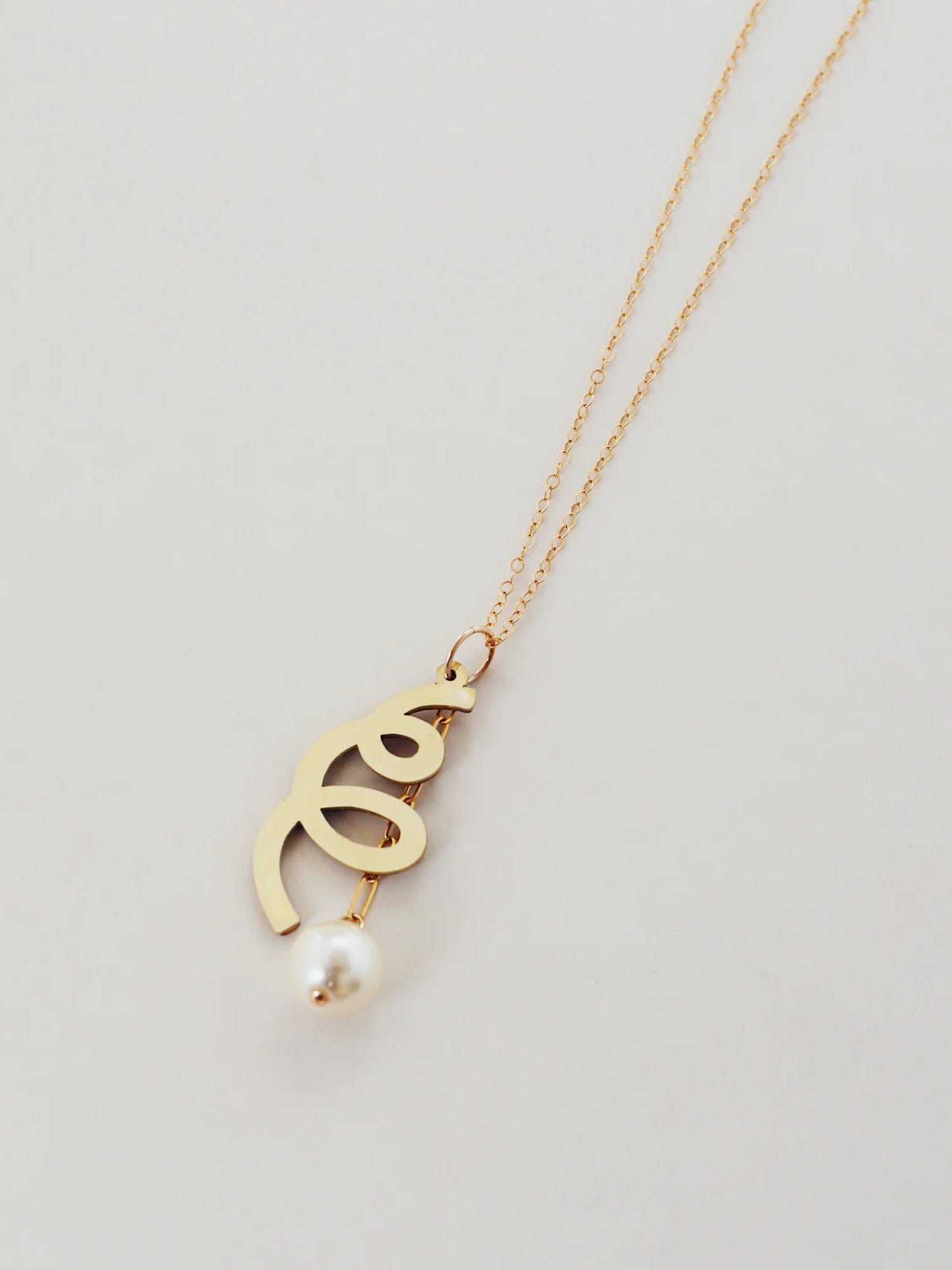 The Every Space Lola necklace with gold filled chain and brass & glass purl pendant by Wolf & Moon