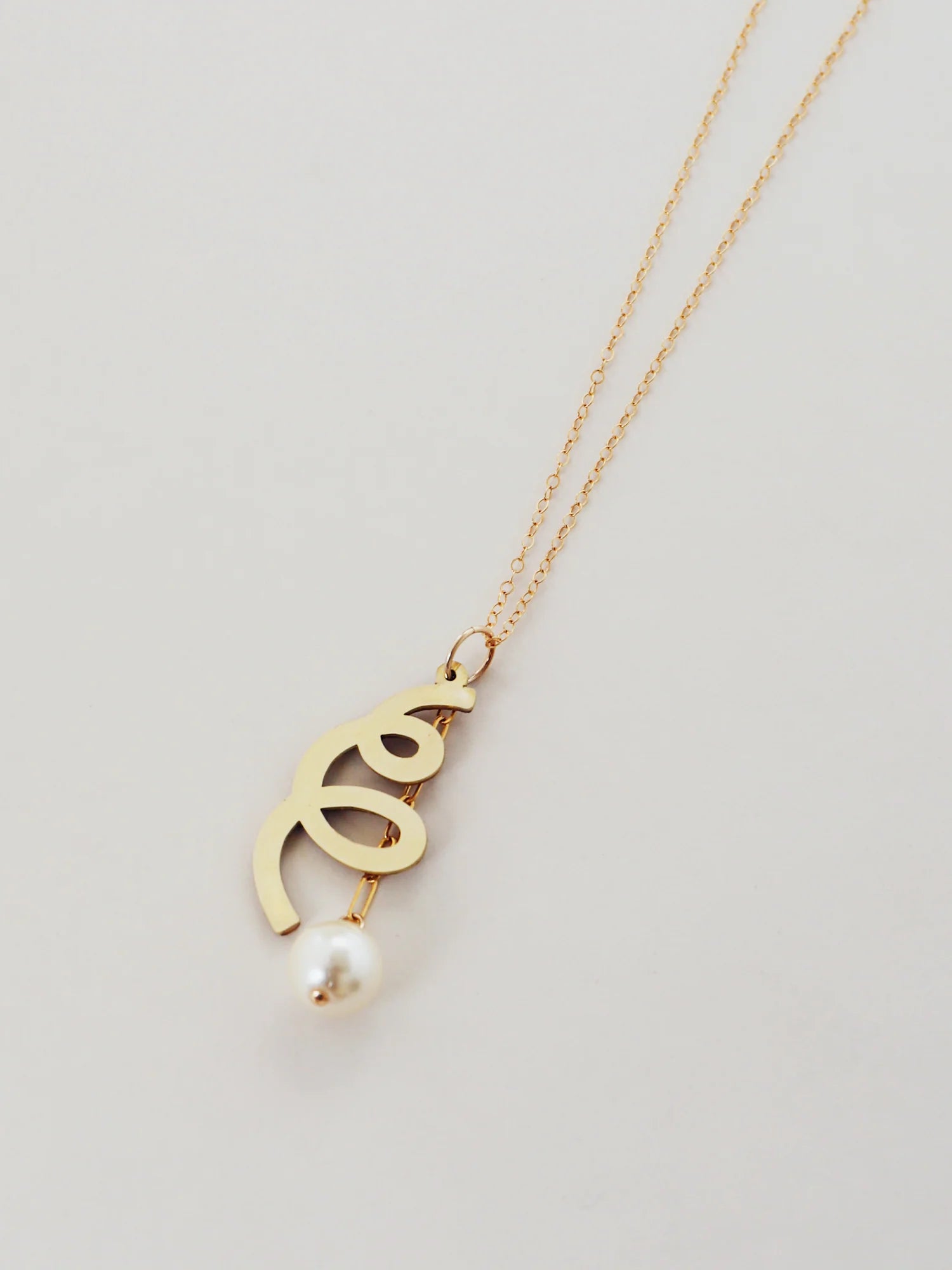 The Every Space Lola necklace with gold filled chain and brass & glass purl pendant by Wolf & Moon