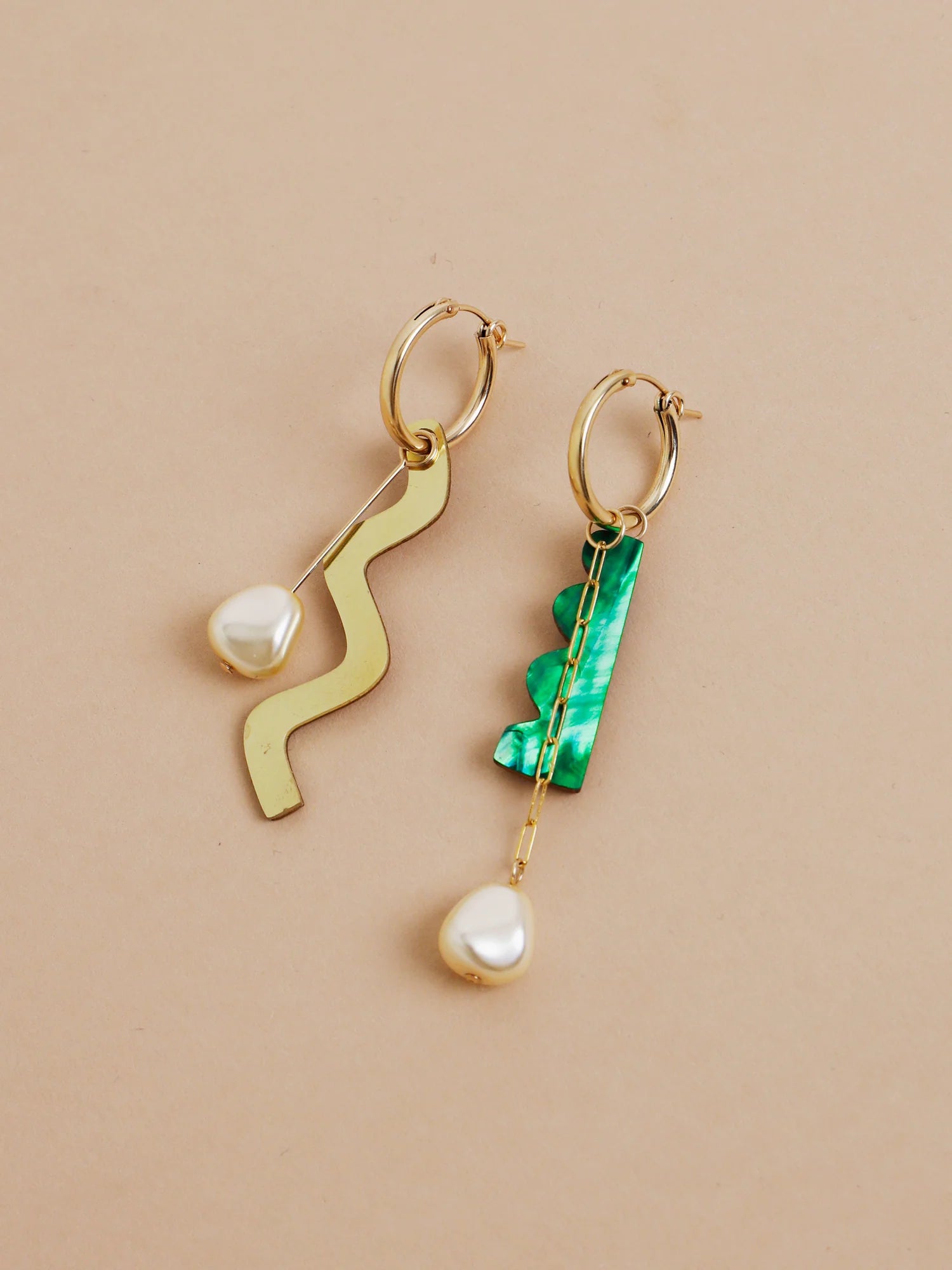 The Every Space mismatched Martha hoop earrings with gold filled hoops and emerald & brass charms by Wolf & Moon
