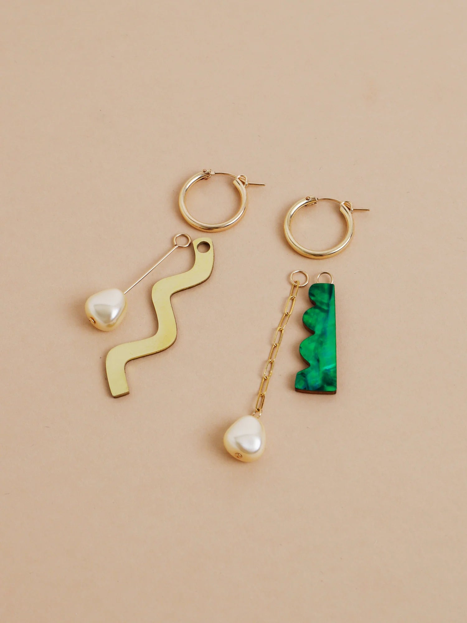 The Every Space mismatched Martha hoop earrings with gold filled hoops and emerald & brass charms by Wolf & Moon