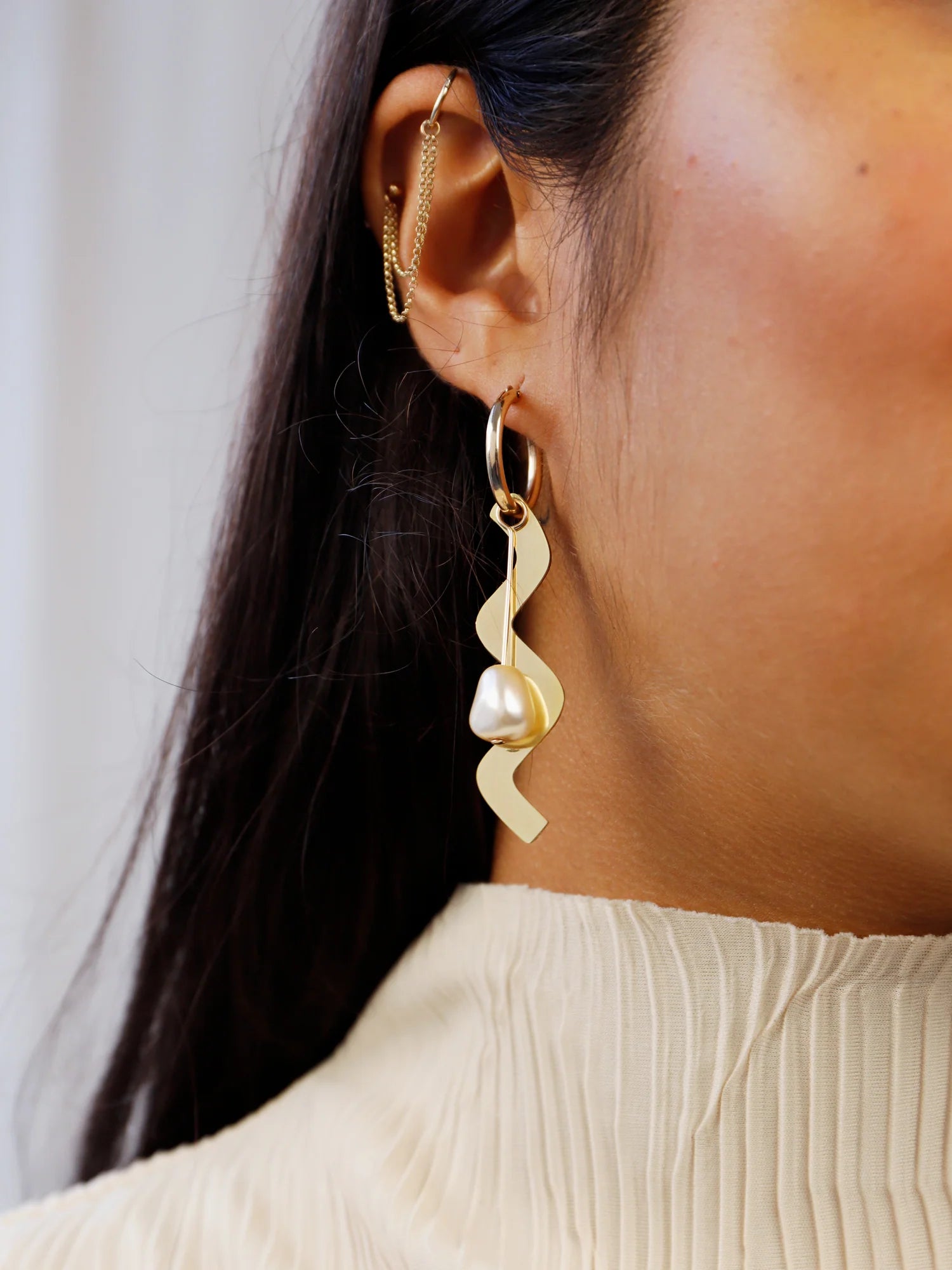 The Every Space mismatched Martha hoop earrings with gold filled hoops and emerald & brass charms by Wolf & Moon