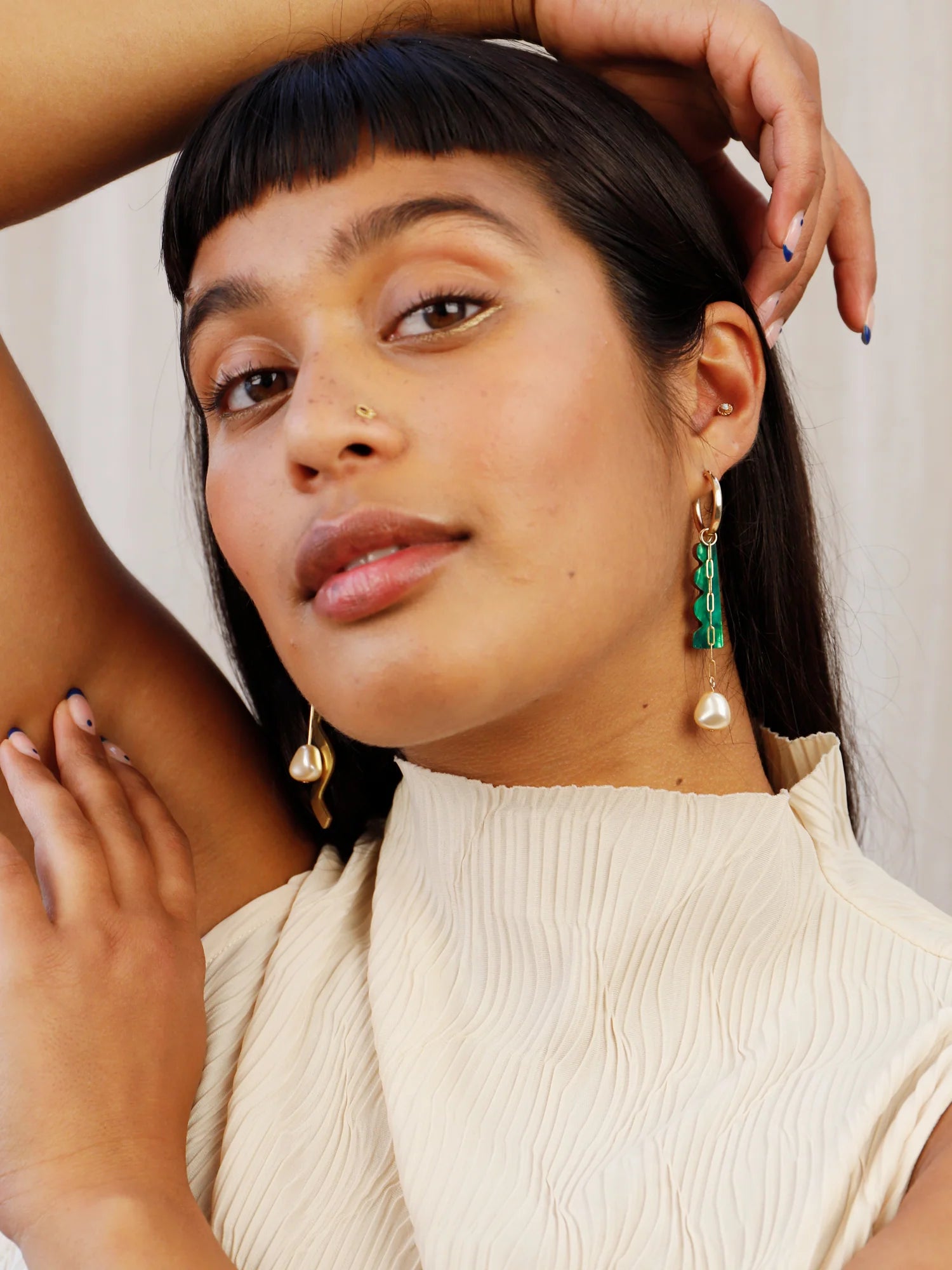 The Every Space mismatched Martha hoop earrings with gold filled hoops and emerald & brass charms by Wolf & Moon