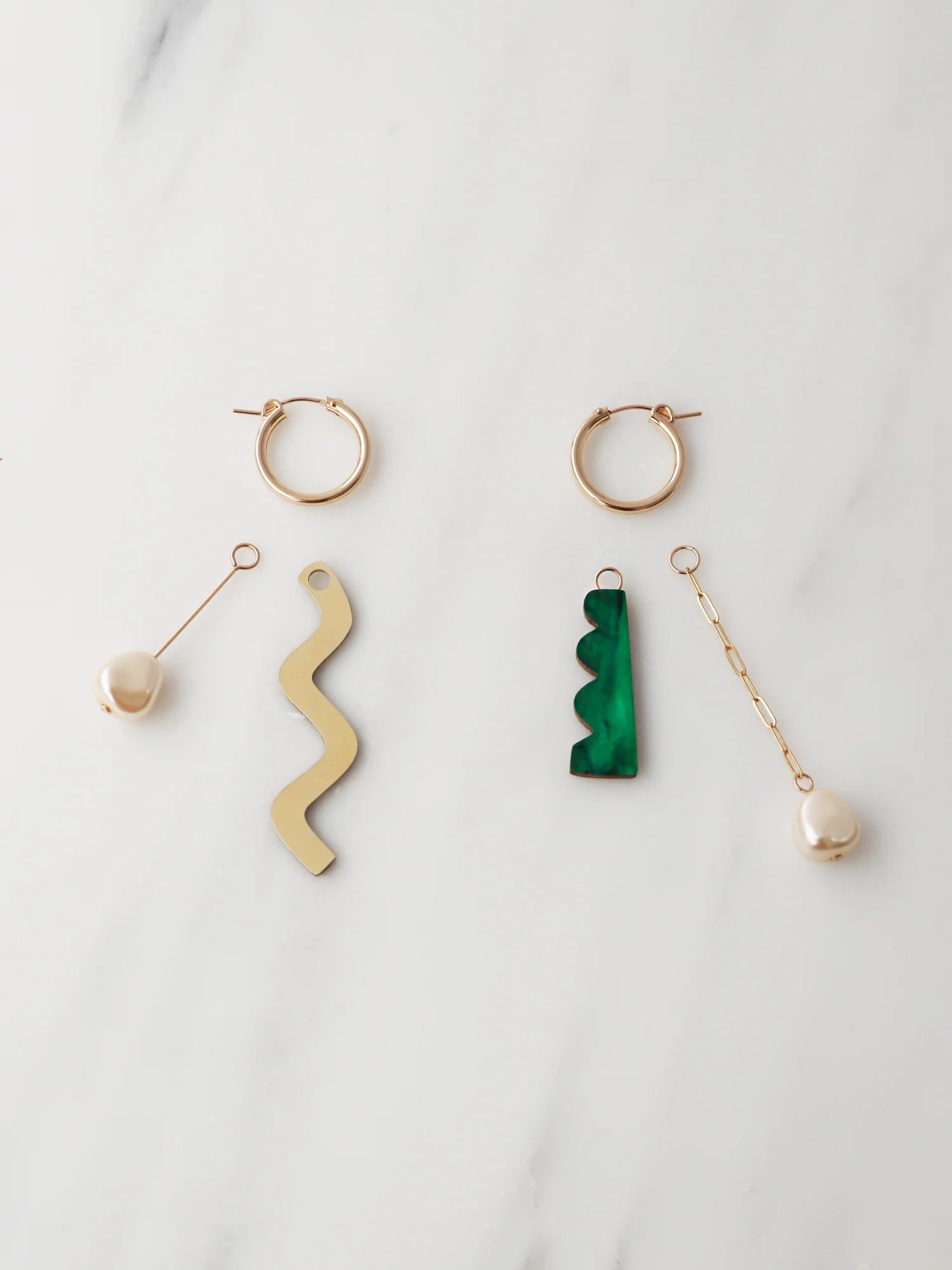 The Every Space mismatched Martha hoop earrings with gold filled hoops and emerald & brass charms by Wolf & Moon