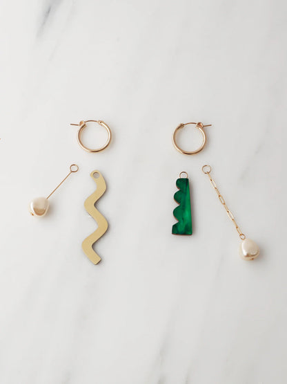 The Every Space mismatched Martha hoop earrings with gold filled hoops and emerald & brass charms by Wolf & Moon