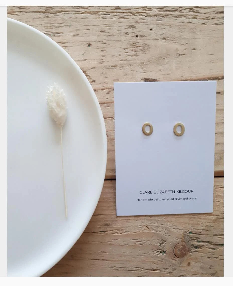 The Every Space handmade recycled brass oval stud earrings with sterling silver pins and scrolls by Clare Elizabeth Kilgour