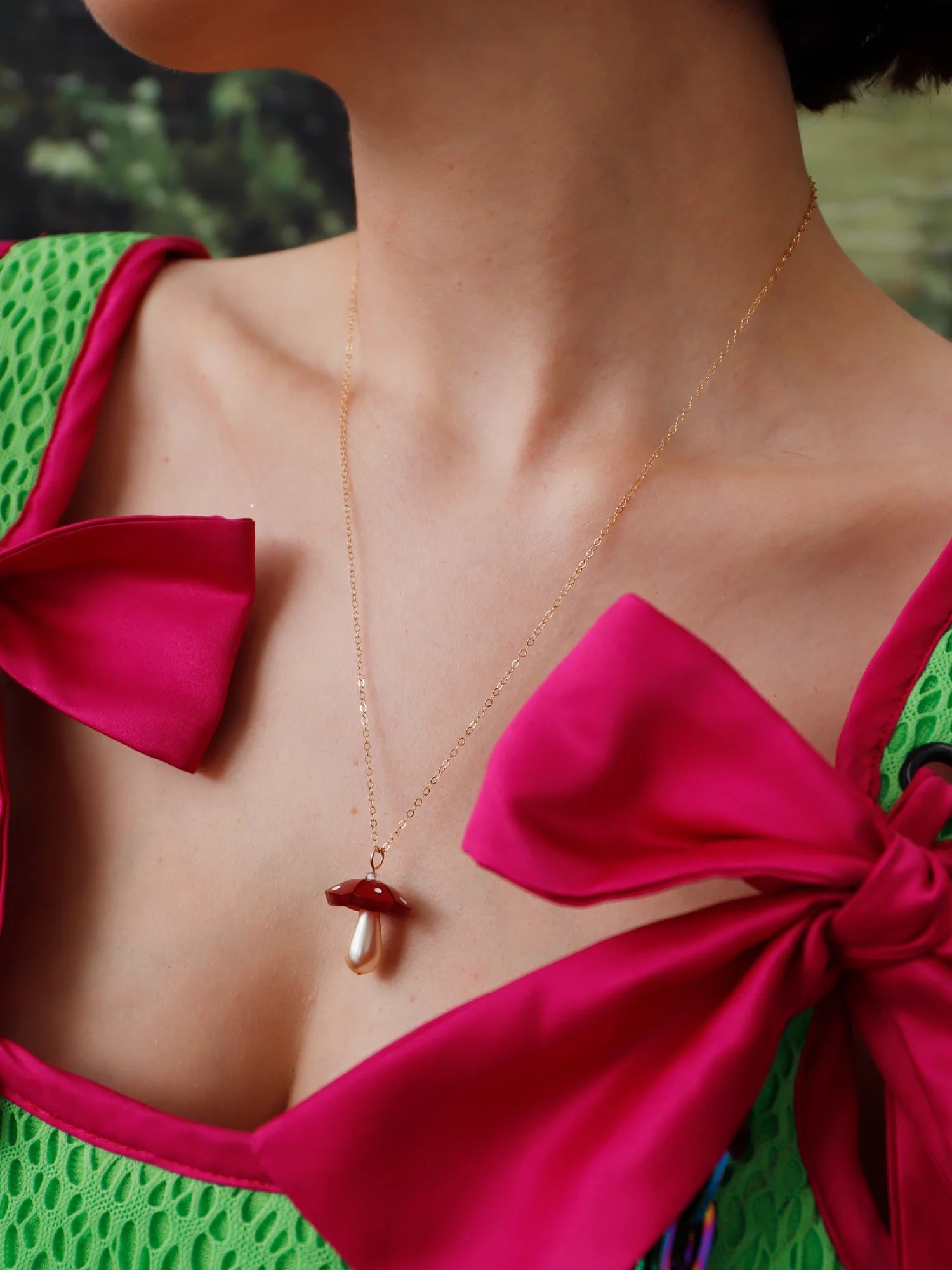 The Every Space Shroom necklace with gold filled chain and red marbled acrylic and glass pearly mushroom pendant by Wolf & Moon