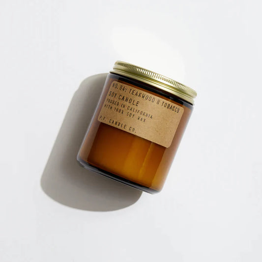 Teakwood & Tobacco 7.2 oz Soy Candle, hand-poured into apothecary-inspired amber jars with signature kraft label and a brass lid, by PF Candle Co.